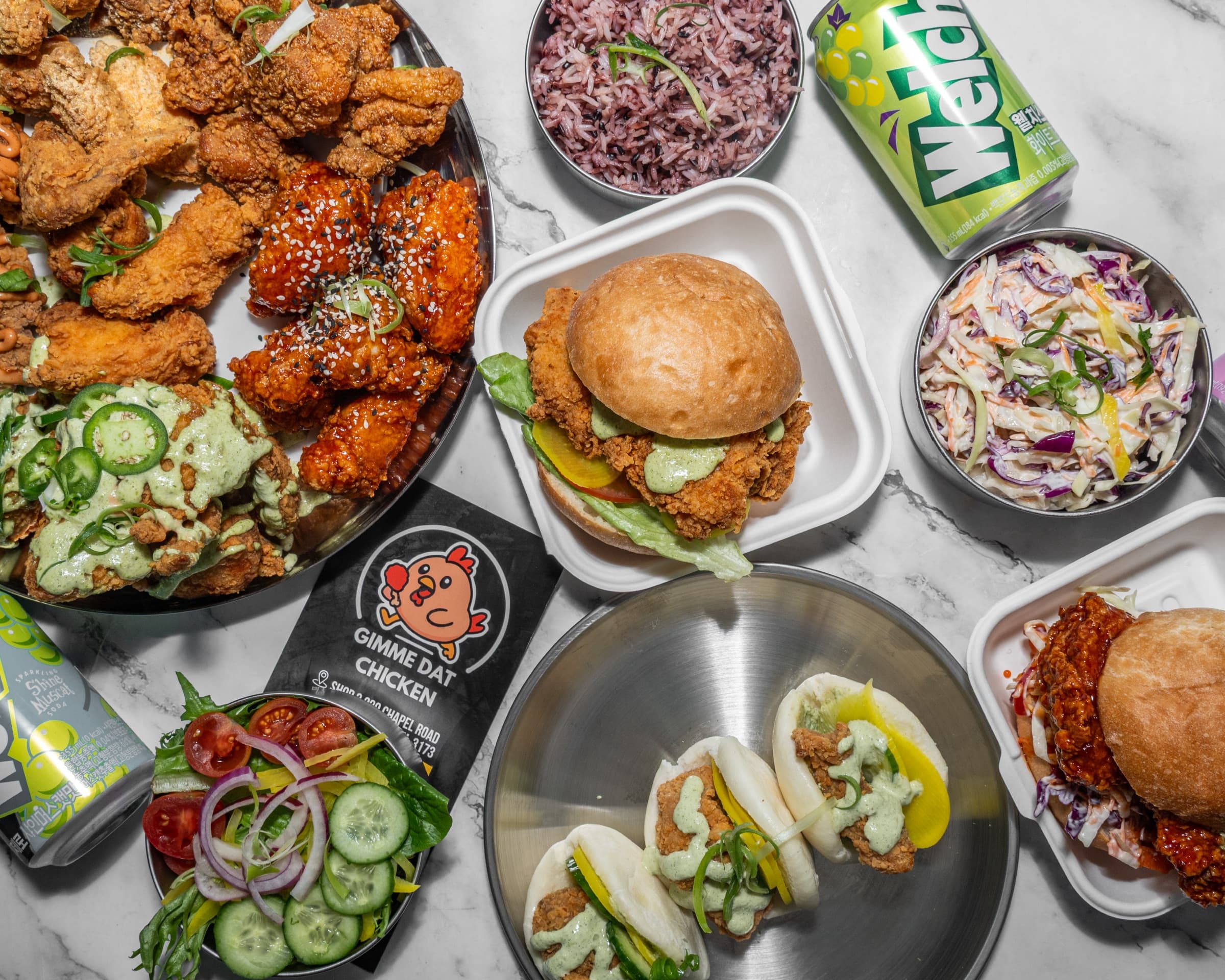 A spread of Gimme Dat Chicken — wings, burgers, baos, sides and drinks