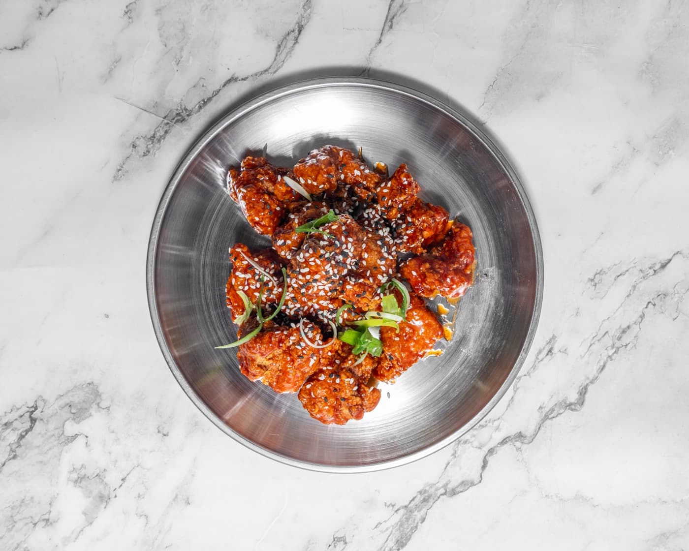 Korean Sweet ’n’ Spicy fried chicken on a steel plate